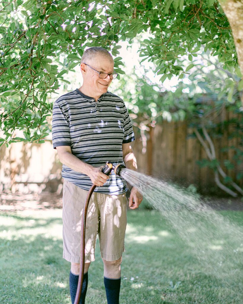 Man watering plant in garden